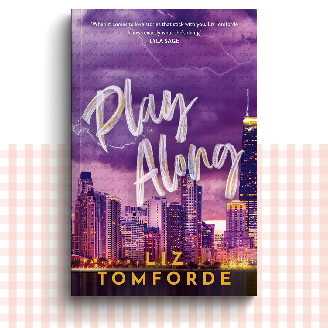 Paperback book cover of 'Play Along' by Liz Tomforde with a Chicago city skyline in the background.