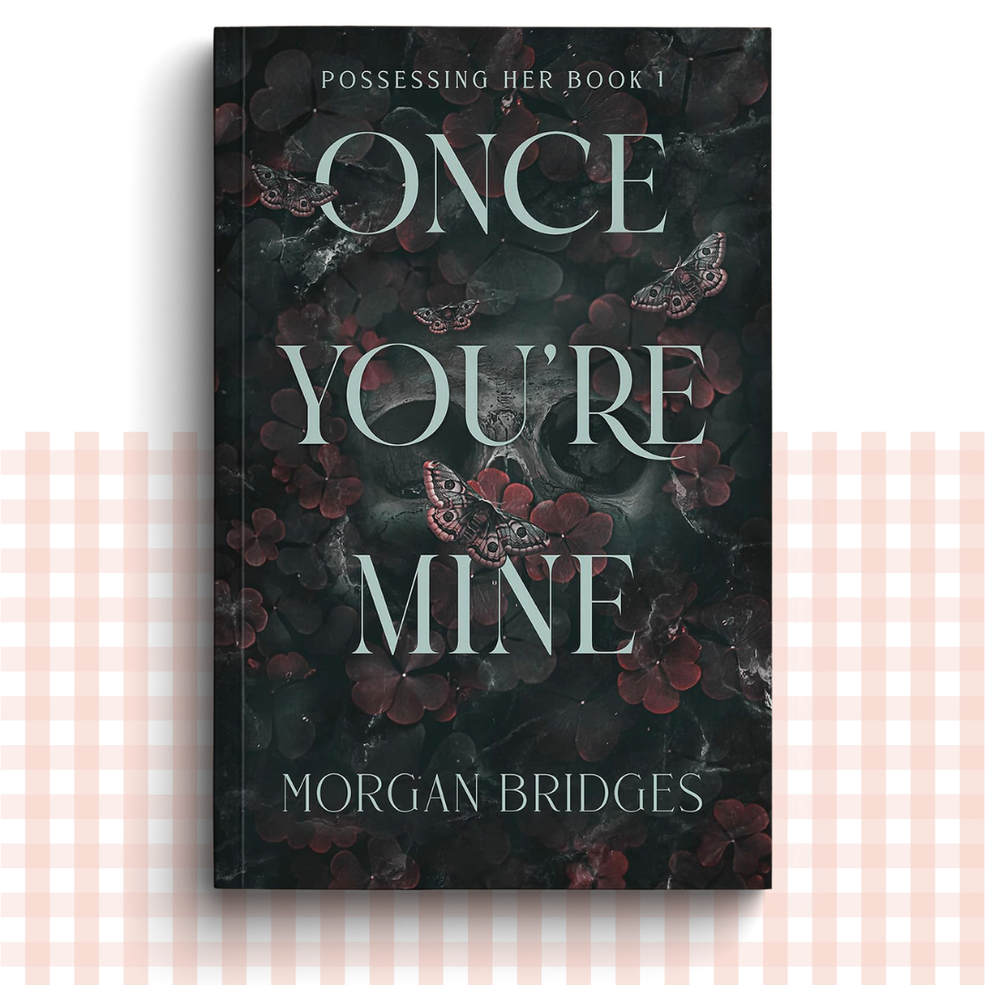 Paperback book cover of 'Once You're Mine' by Morgan Bridges with dark floral design
