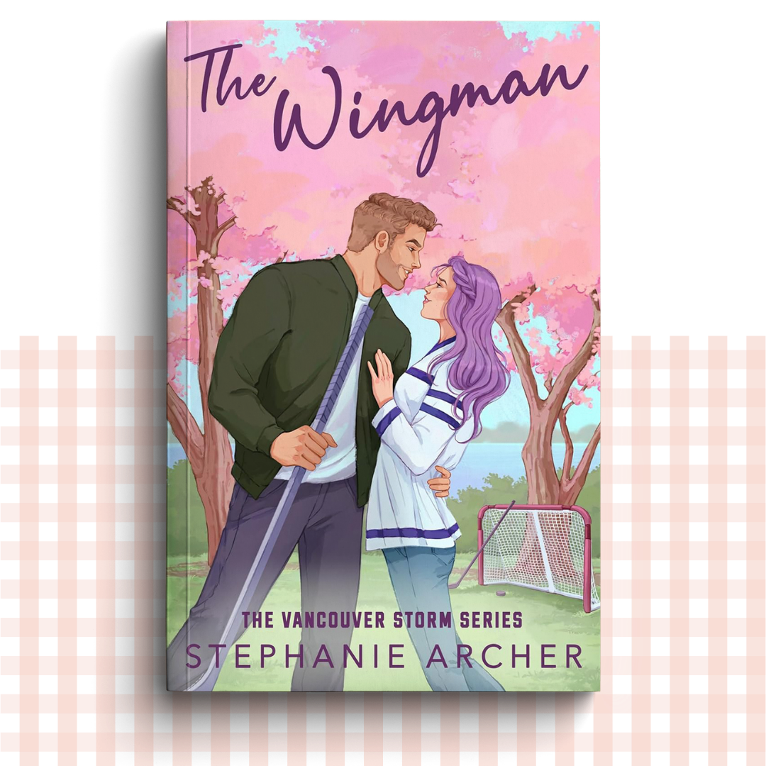 Paperback book cover of 'The Wingman' by Stephanie Archer with a couple in a park setting.
