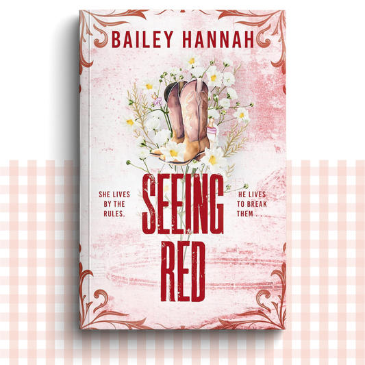 Paperback book cover of 'Seeing Red' by Bailey Hannah with red cowboy boots and flowers.