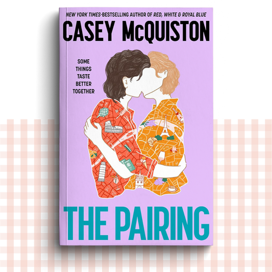 Paperback book cover of 'The Pairing' by Casey McQuiston with two faceless characters embracing on a light purple background.