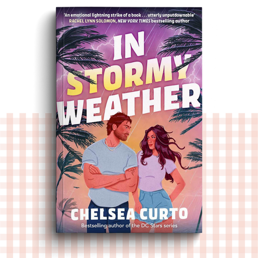 Paperback book cover of 'In Stormy Weather' by Chelsea Curto with a couple under palm trees and lightning.