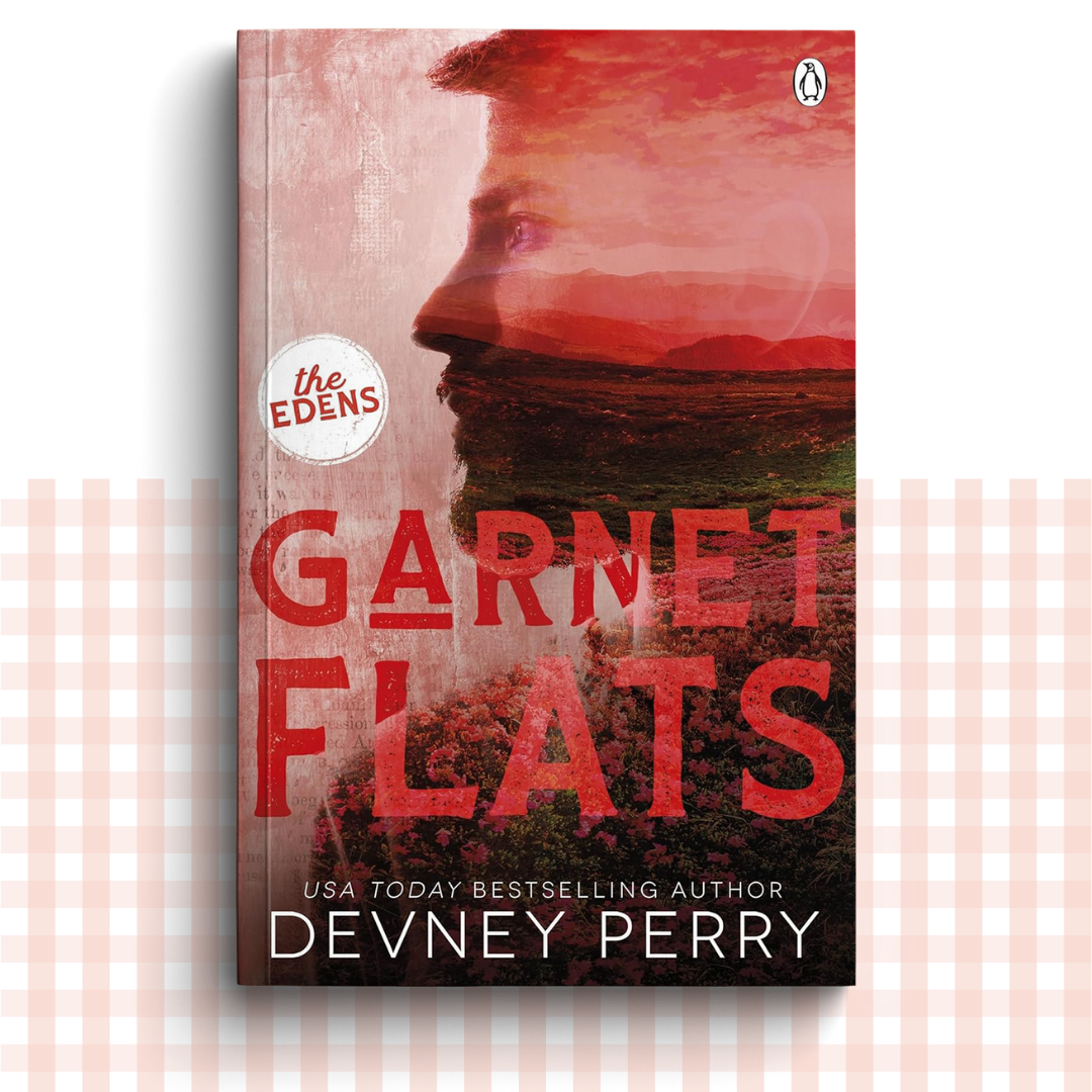 Paperback book cover of 'Garnet Flats' by Devney Perry with a red landscape design and a man's side profile.