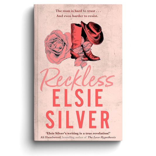Book cover of 'Reckless' by Elsie Silver with cowboy boots and a rose on a pink background.