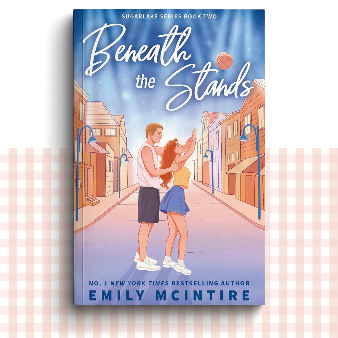 Paperback book cover of 'Beneath the Stands' by Emily McIntire with a couple playing basketball in the street.