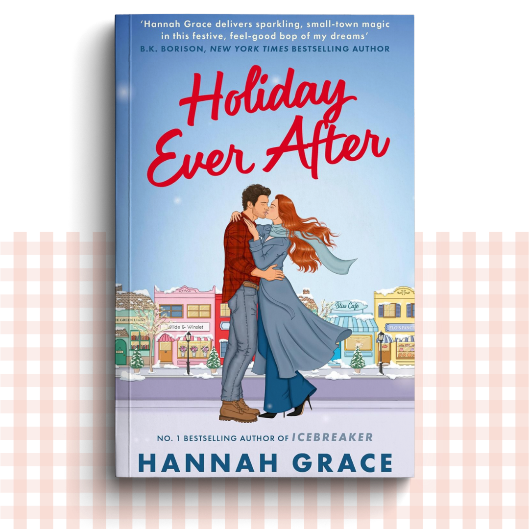 Paperback book cover of 'Holiday Ever After' by Hannah Grace with a couple embracing in a snowy town.