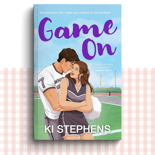 Paperback book cover of 'Game On' by Ki Stephens with a couple on a sports field.