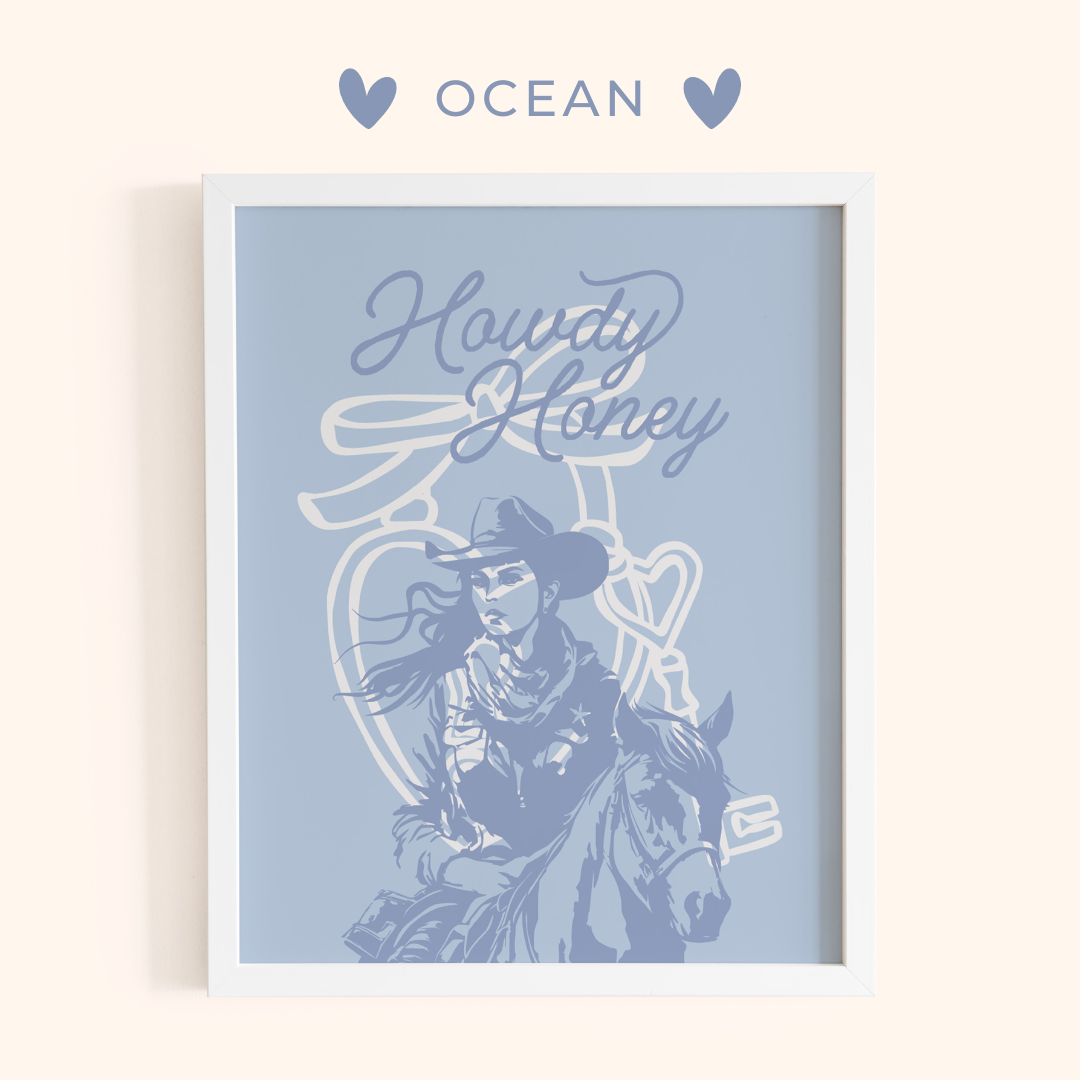 Framed artwork with a cowboy and horse illustration and 'Howdy Honey' text on a light blue background, branded 'Ocean'