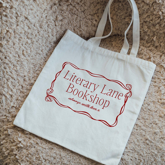 Canvas tote bag with 'Literary Lane Bookshop' text on a textured surface