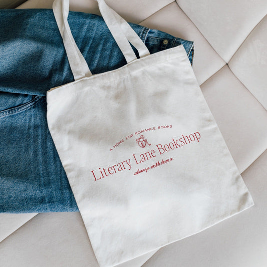 White tote bag with 'Literary Lane Bookshop' text on a textured surface