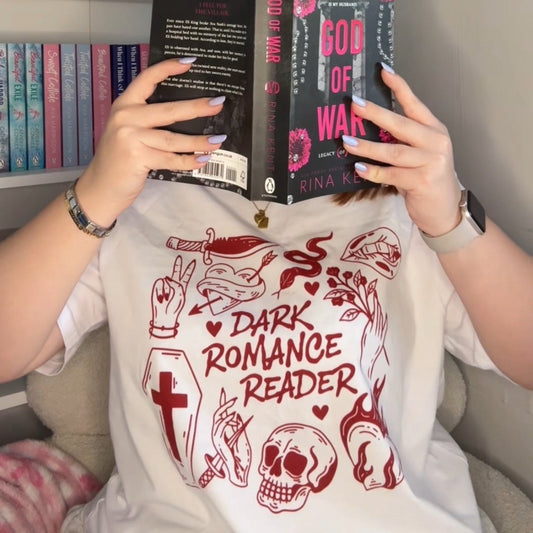 Person wearing a 'Dark Romance Reader' t-shirt holding a book titled 'God of War' by Rina Kent
