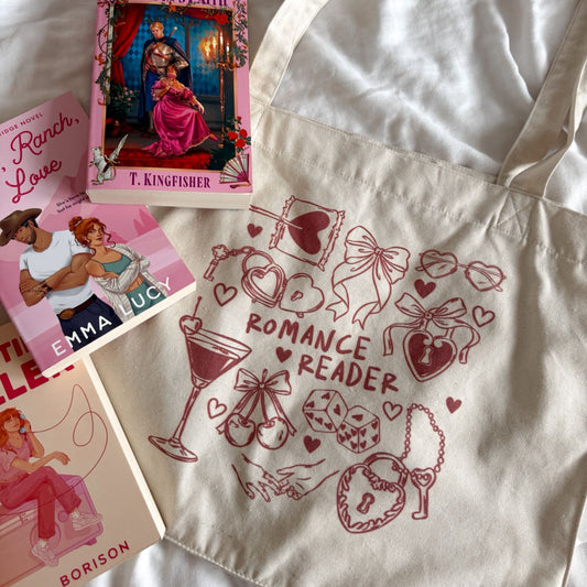 Tote bag with 'Romance Reader' design and books on a white surface