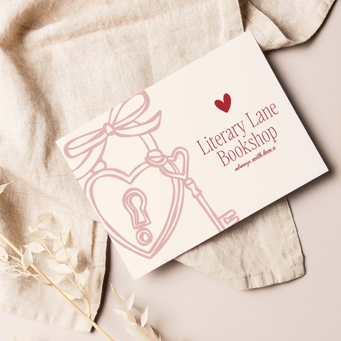Card with heart and key design on a textured surface, featuring 'Literary Lane Bookshop'.