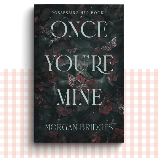 Paperback book cover of 'Once You're Mine' by Morgan Bridges with dark floral design