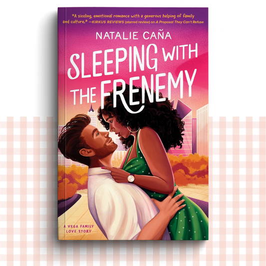 Paperback book cover of 'Sleeping with the Frenemy' by Natalie Caña with a bright design of the characters embracing in front of a city skyline.