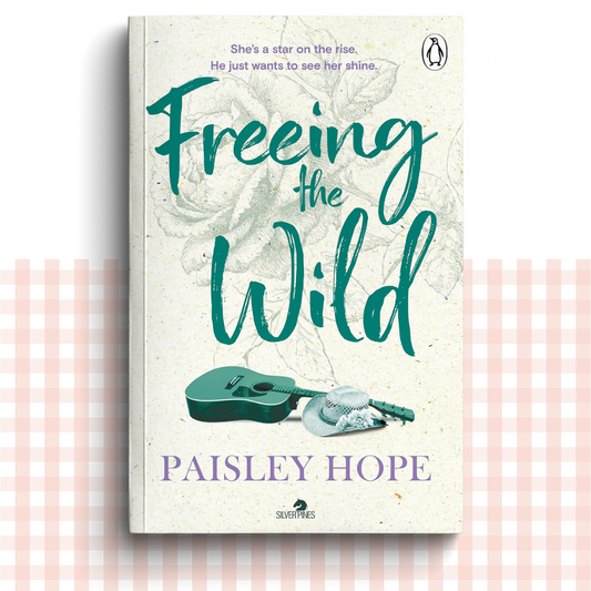 Paperback book cover of 'Freeing the Wild' by Paisley Hope with a green and cream design and a green acoustic guitar.