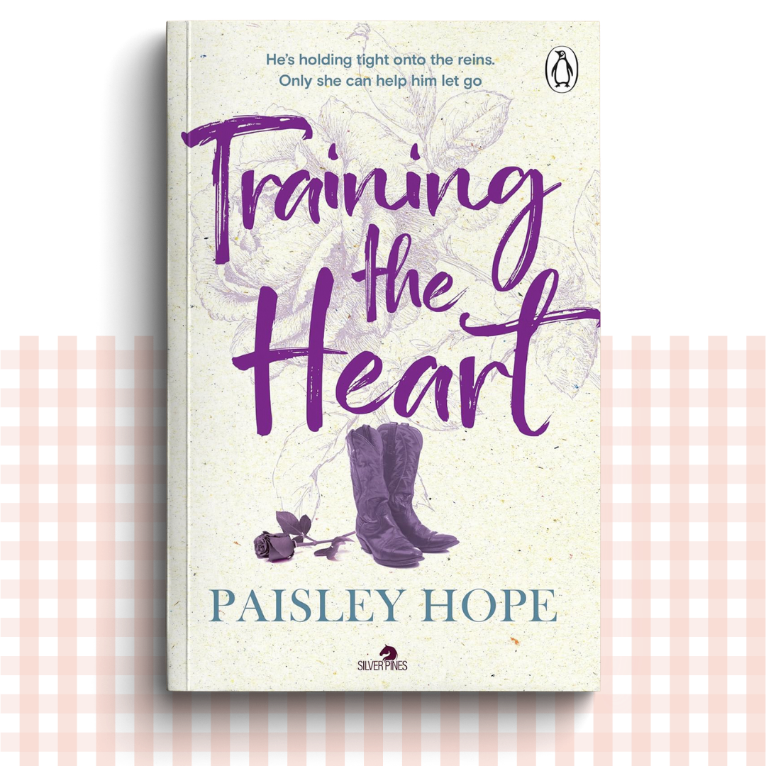 Paperback book cover of 'Training the Heart' by Paisley Hope with a purple and cream design, and a pair of purple cowboy boots.