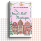 Paperback book cover of 'The Jingle Bell Boutique' by Victoria Jane with a festive village design